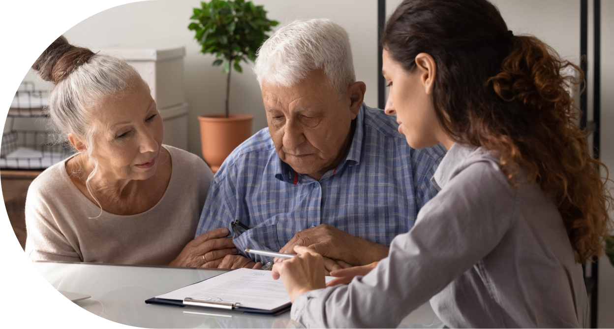 A woman explaining a contract to two older adults
